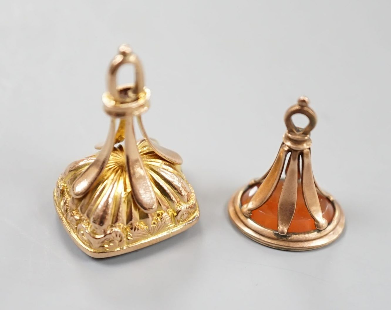 A late Victorian yellow metal and carnelian set fob seal, 23mm and a George V 9ct gold and bloodstone set fob seal.